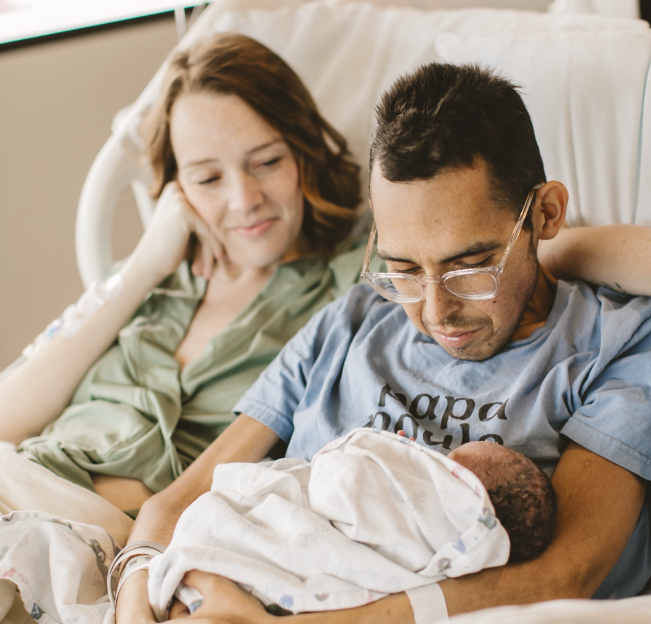Tanner Martin holds his newborn daughter shortly before his passing