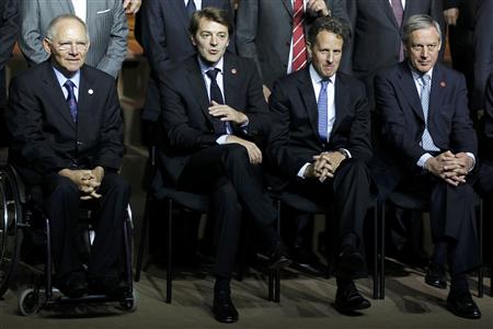 The German Finance Minister Wolfgang Schauble, France's Finance Minister Francois Baroin, the U.S. Treasury Secretary Tim Geithner and France's Central Bank Governor Christian Noyer pose together during the G20 meeting in Paris.