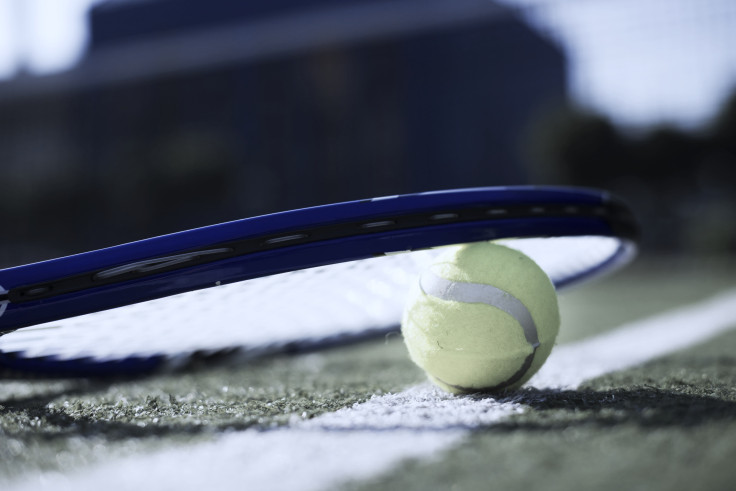 Racket and Tennis ball on the Floor