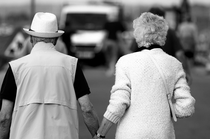 A man and a woman walking holding hands