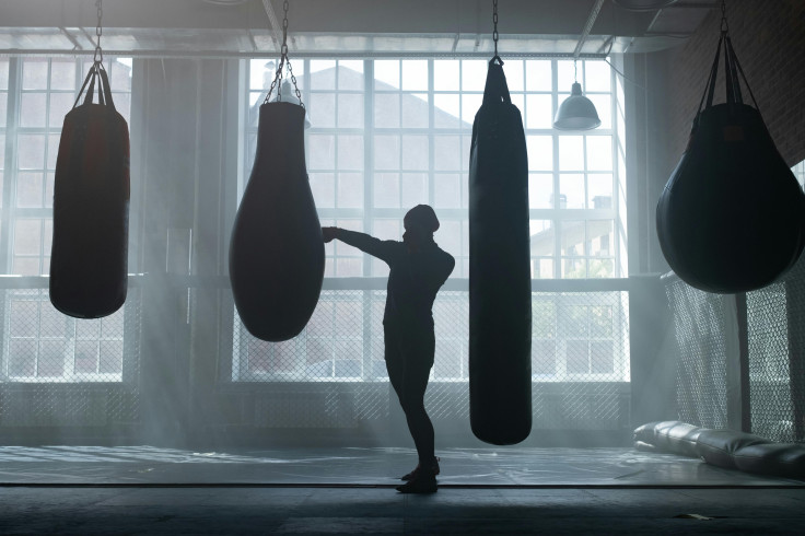 Silhouette of a person punching a punching bag