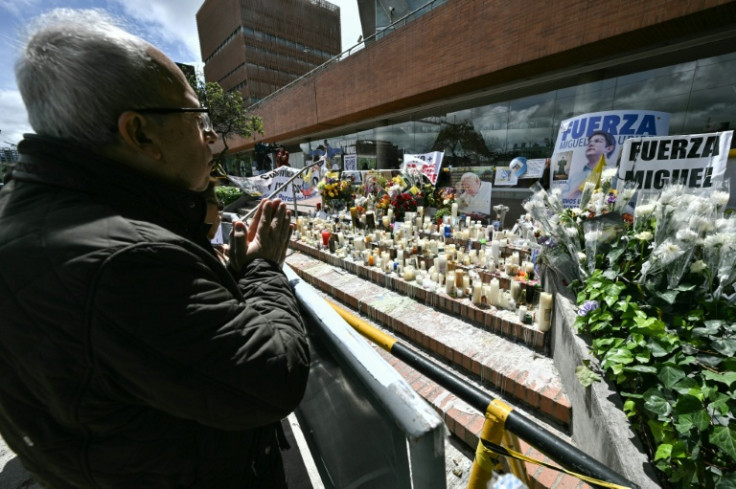 A man prays for the health of the Colombian presidential candidate Miguel Uribe during his surgery outside the Fundacion Santa Fe clinic in Bogota on June 16, 2025. Miguel Uribe, who was shot last week at a public event, underwent emergency surgery on Jun
