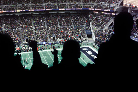 A crowd of people watching a football game