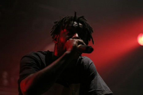 Person holding a mic rapping