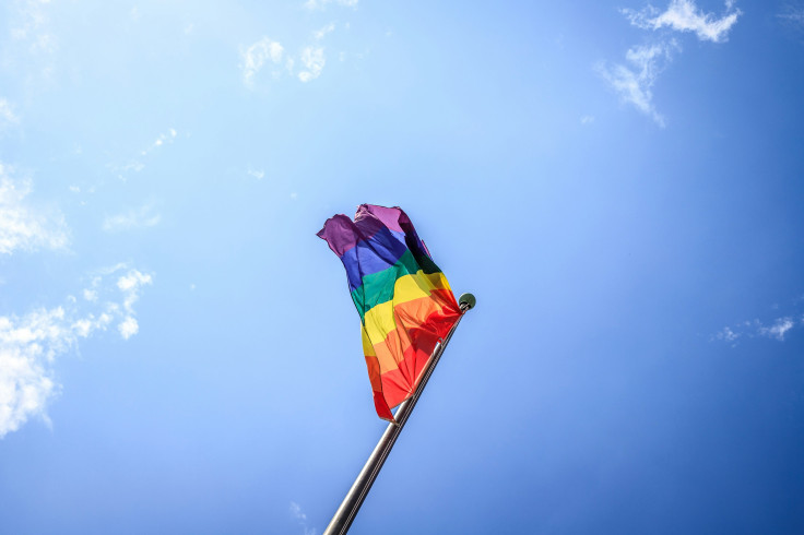 Multi colored flag under a blue sky during the daytime