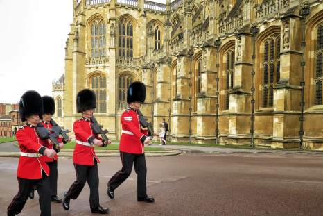 four royal guard marching outside palace