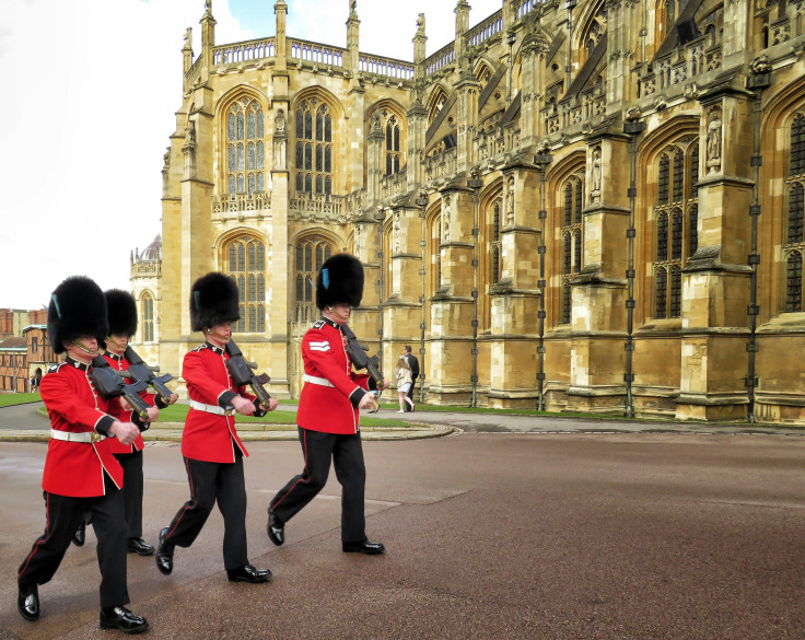 four royal guard marching outside palace