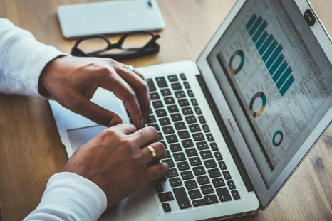 A person using a laptop with statistical results
