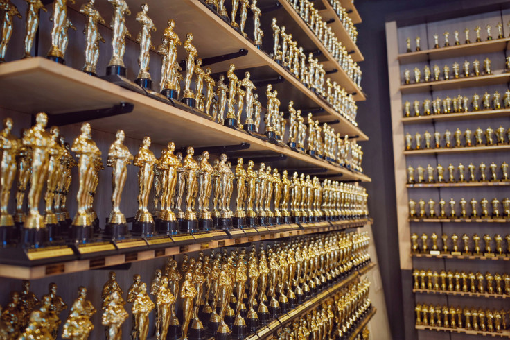 Gold and silver trophy on brown wooden shelf