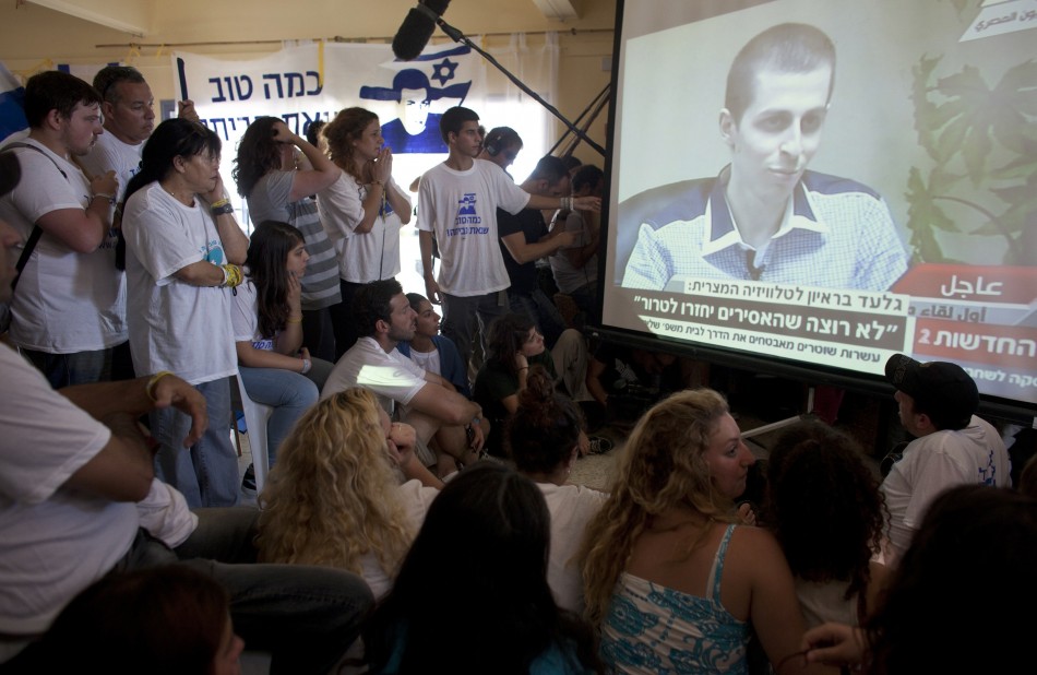 Israelis in Mitzpe Hila watch a television broadcast of an interview with Gilad Shalit