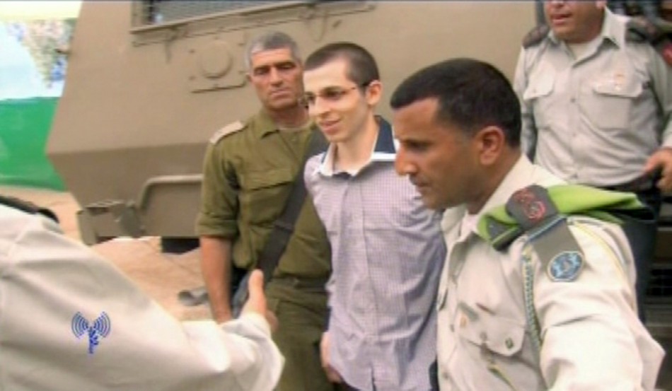 Gilad Shalit is greeted by Israeli army officers at Kerem Shalom