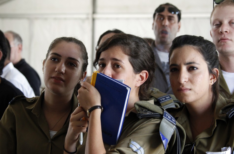 Soldiers from the Israeli army Spokespersons Unit react at Tel Nof air base in central Israel