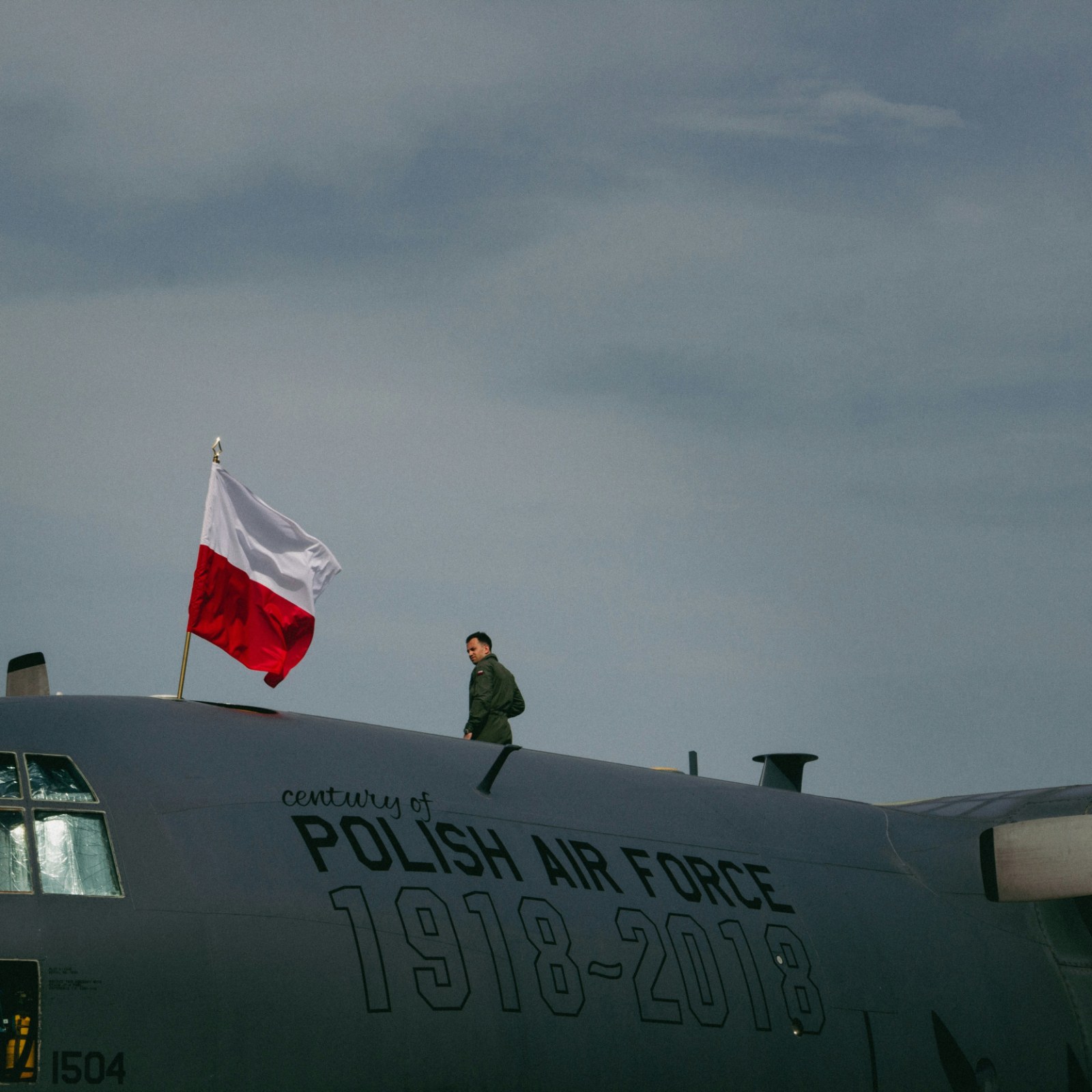 A soldier standing on top of a polish air force 