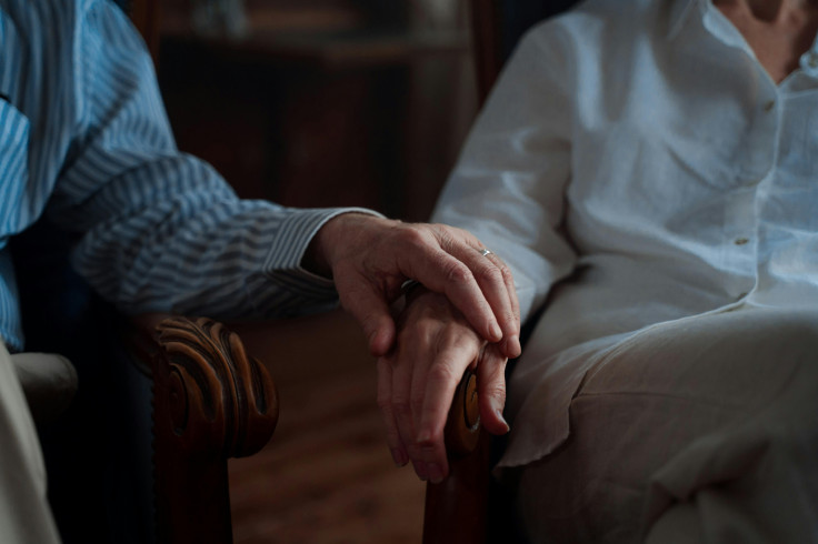 Old couple holding hands