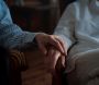 Old couple holding hands