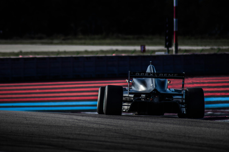 Black F1 race car on a race track during daytime