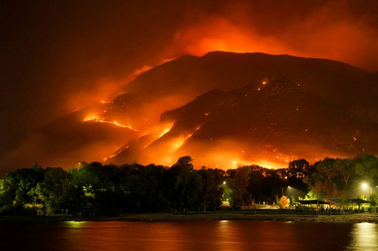 A large fire is burning in the mountains