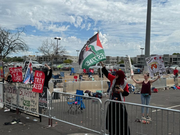 Small group of protesters outside the Charlie Kirk memorial