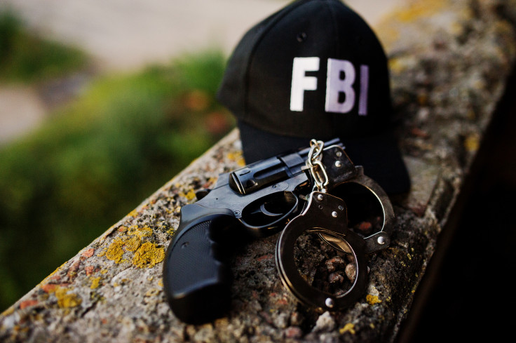 Fbi cap with revolver and handcuff