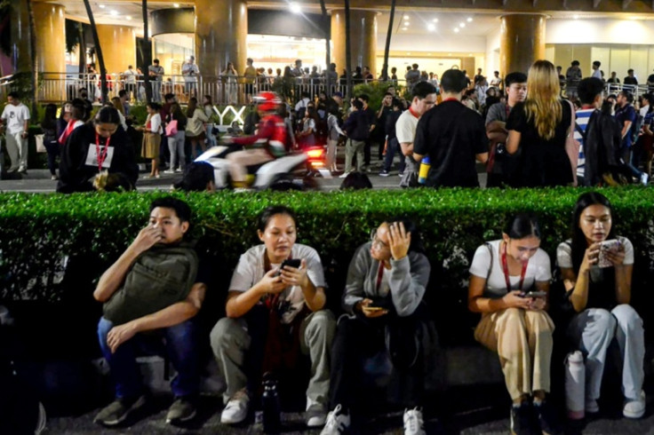 call-center-employees-surf-mobile-phones-they-gather-outside-their-office-building-after