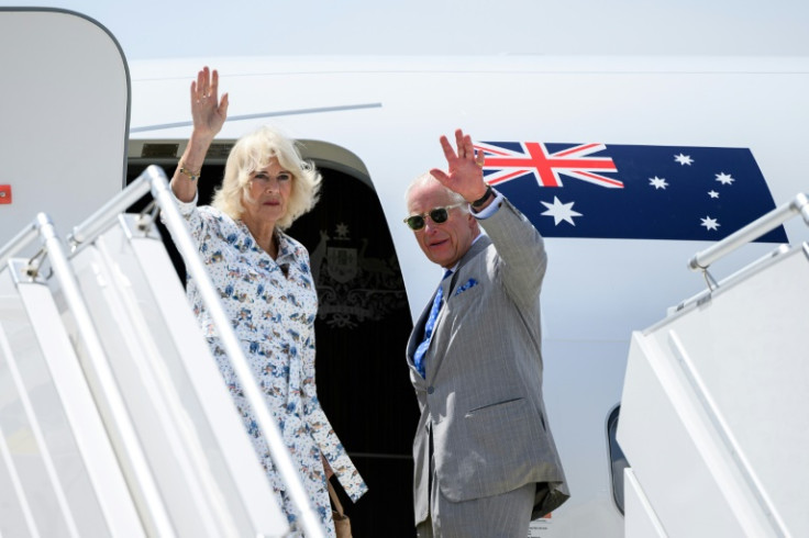 Britain's King Charles and Queen Camilla wave goodbye as they board a flight at Sydney Airport for Samoa