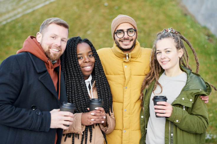 Photo of People Smiling While Holding Disposable Cups