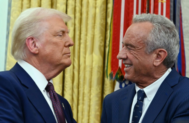 The new US Secretary of Health and Human Services Robert F. Kennedy Jr. shakes hands with President Donald Trump after a swearing-in ceremony at the White House
