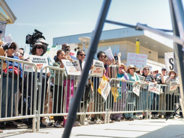 Group of people rally against RFK