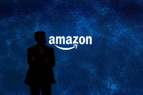 Man standing in front of Amazon logo