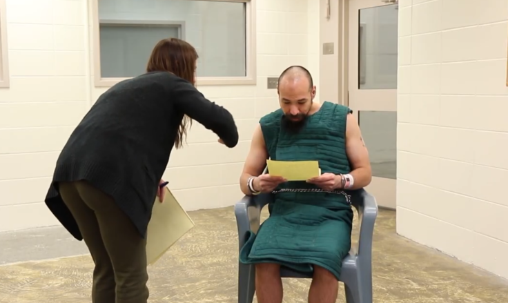 An inmate wearing an anti suicide smock during an interview.