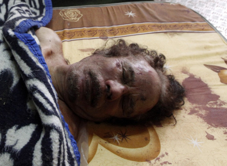 Dead body of Gaddafi is displayed inside a metal storage freezer in Misrata