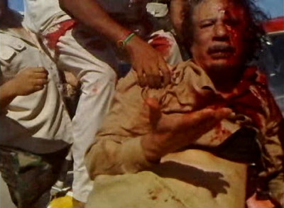 A National Transitional Countil NTC fighter pulls Libya039s former leader Muammar Gaddafi onto a miltary vehicle in Sirte in this still image taken from video A National Transitional Countil NTC fighter pulls Libya039s former leader Muammar Gaddafi onto a miltary vehicle in Sirte in this still image taken from video