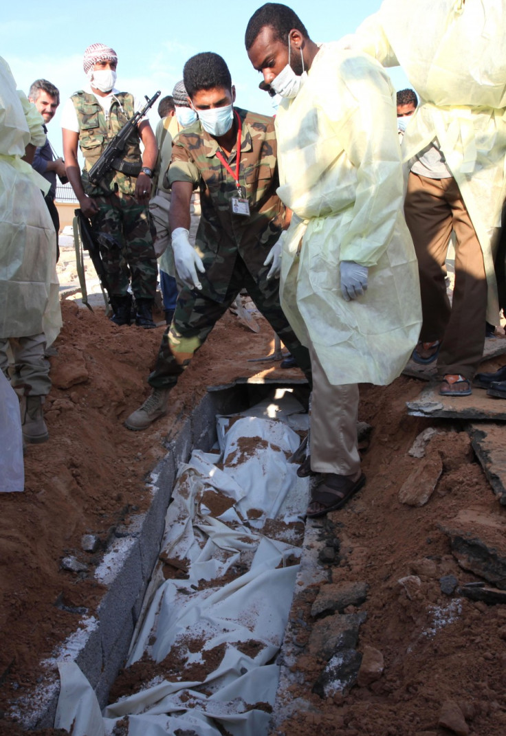 Medical and militia officials in Tripoli exhume two corpses from a site they identified as a mass grave