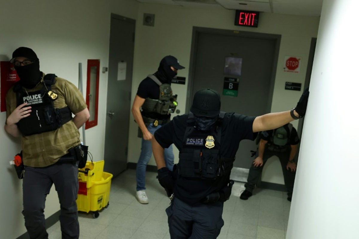 Armed agents with shields from different federal agencies