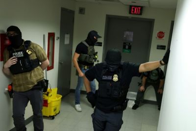 Armed agents with shields from different federal agencies