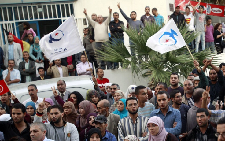 Supporters of the Islamist Ennahda movement hold party flags during Abdelhamid Jlazzi's speech outside the party's headquarters in Tunis