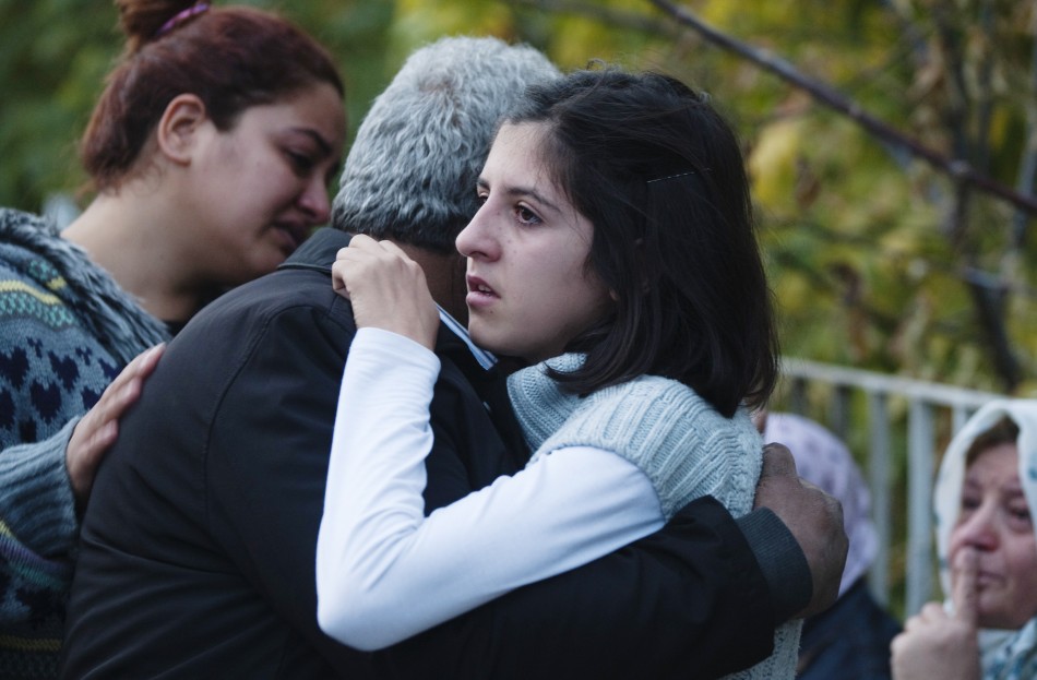 Relatives of victims of an earthquake embrace each other in Ercis on Monday.
