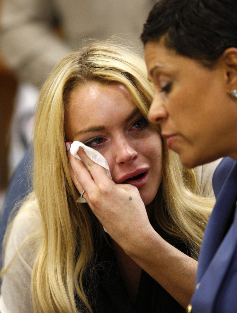Lindsay Lohan reacts beside her attorney Shawn Chapman Holley as Judge Marsha Revel rules that Lohan had violated her probation on a 2007 drunken driving charge in Beverly Hill
