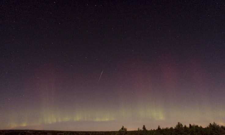 A view of a shooting star (Draconid) and northern lights near Skekarsbo at the Farnebofjardens national park, 150 km north of Stockholm on October 8, 2011.