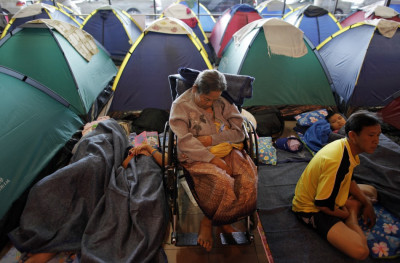 People evacuated from areas affected by floods pass time at a collective shelter at Don Mueang airport in Bangkok People evacuated from areas affected by floods pass time at a collective shelter at Don Mueang airport in Bangkok