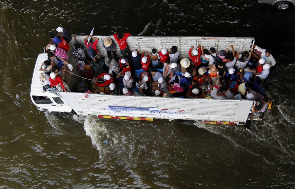 People are evacuated on a truck from a flooded area in Bangkok