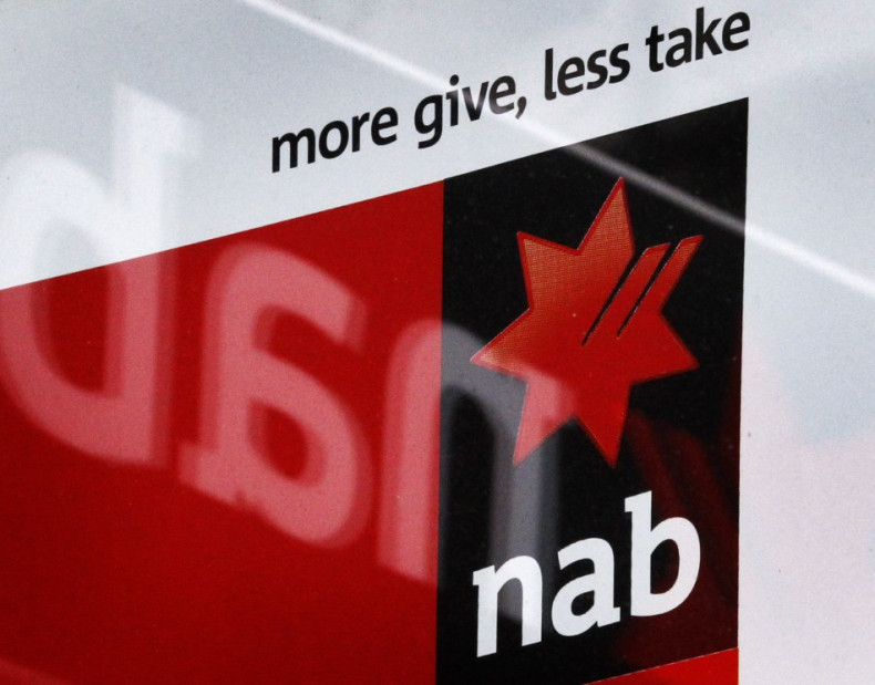 A National Australia Bank sign is reflected in the window of a shop front in Sydney