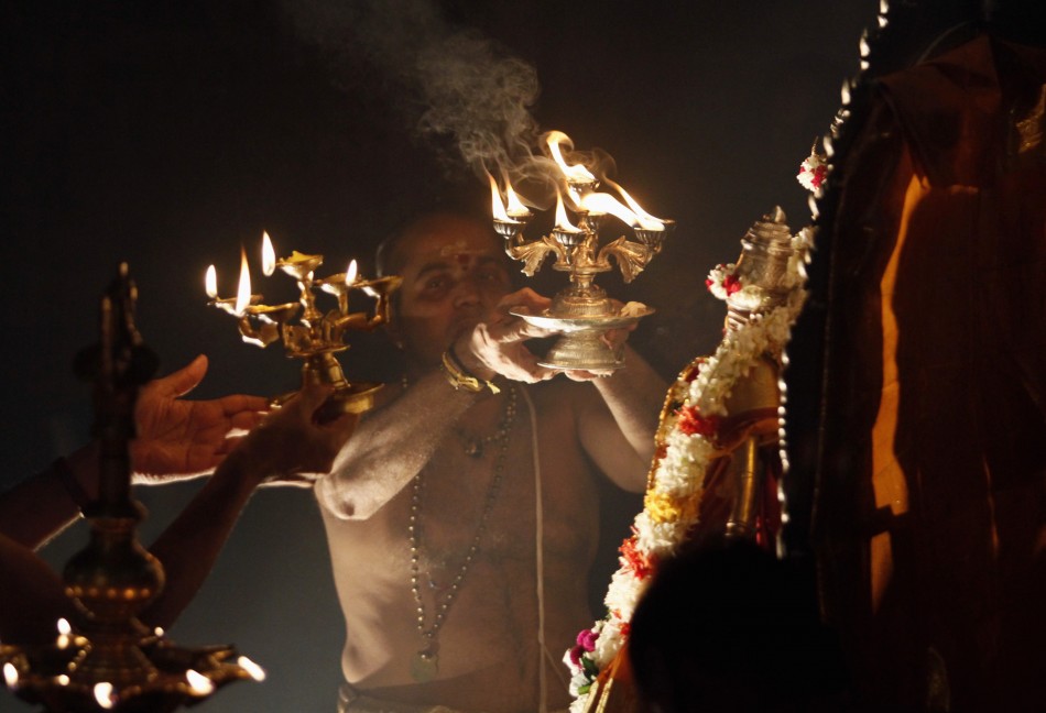 A Hindu priest makes a blessing during the festival of Diwali at Shivm Kovi temple in Colombo