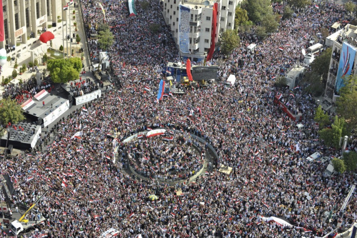 A photo taken from a helicopter shows supporters of Syrian President Bashar al-Assad's gathering during a rally at al-Sabaa Bahrat square in Damascus