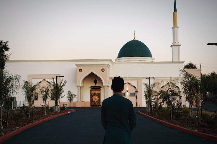 a man stands outside a mosque