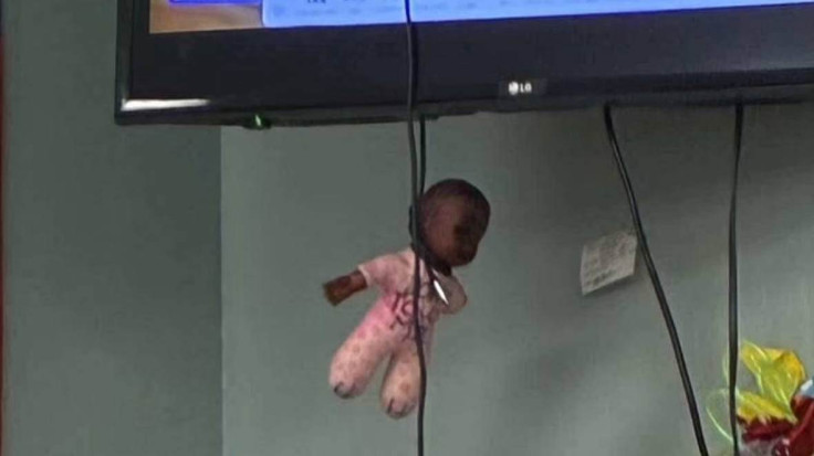 Black doll tied in a cord