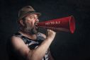 Man holding a megaphone saying No to AI