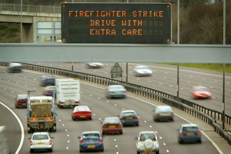 A SIGN ENCOURAGING MOTORISTS TO DRIVE WITH CARE OVERLOOKS THE M25 MOTORWAY IN BUCKINGHAMSHIRE.