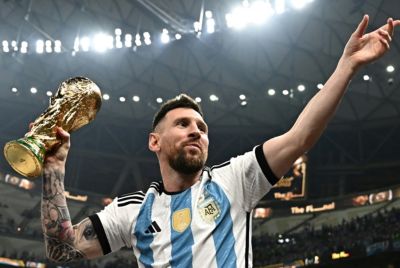 Lionel Messi holding up the World Cup trophy in 2022