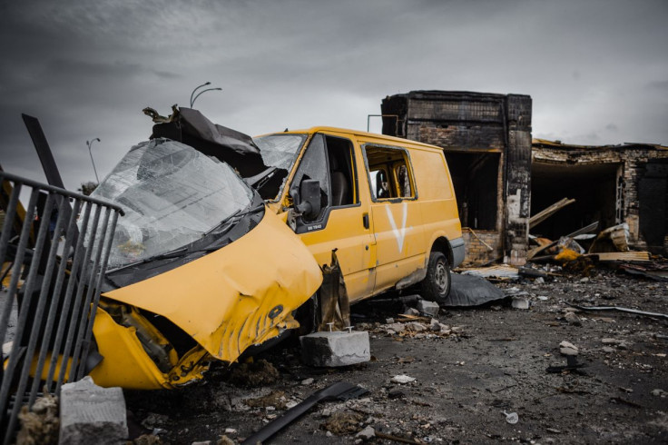 A destroyed yellow van amidst war-torn debris in Borodyanka, Ukraine